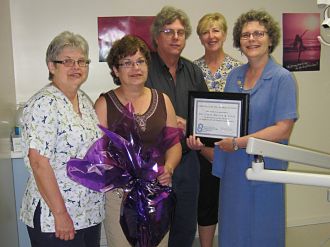 Accepting a gift basket and certificate of appreciation are (L-R) Carol Bigg, Donna Cooper, Dr. Layne Butler, Janice Gordon and making the presentation is Debbie MacDonald Moynes, executive director of Community Care for Seniors.